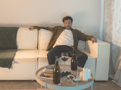 An alcoholic man drinking wine 