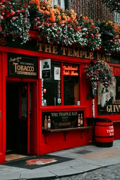 The iconic red building in Temple Bar, Dublin, Ireland, featuring a green rooftop brimming with plants