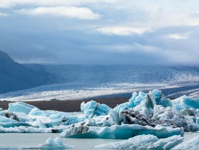 A photo of melting glaciers and icebergs during the day, illustrating the effects of global warming