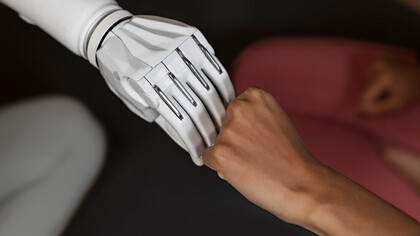 A woman and a robot joining hands 