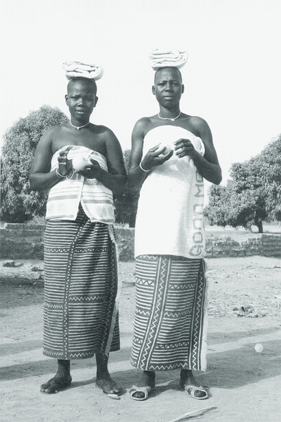 Ill. 70. Nansun Suko and Araba Diarra wearing a post-excision retreat dress. This includes the N’Gale wrapper. Compound of Salimata Kone, Kolokani, March 1977. Both women died within a few years after this photograph was taken.  
Photocredit Sarah C. Brett–Smith  
