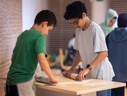Karam and Hamza learn how to make Punjabi parathas. Courtesy of Ingenium. The Canada Agriculture and Food Museum. Photo by Lindsay Ralph
