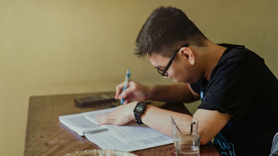 A person sat working at a desk. Concentration is a strategy that focuses on the best point of attack