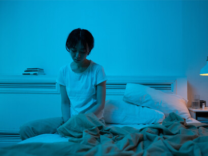 A woman stays in her bed instead of going into the world