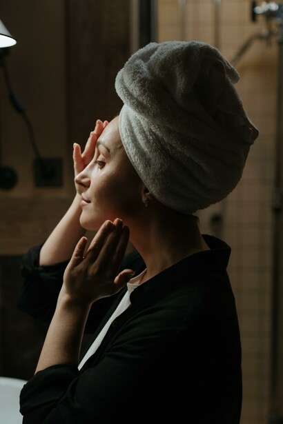 Woman applying skin care product