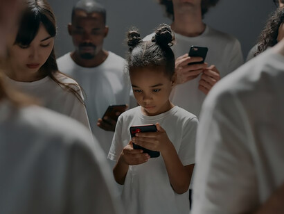A group of people dressed in white, captivated by their phones, vividly depicts the modern allure and challenges of social media and phone addiction