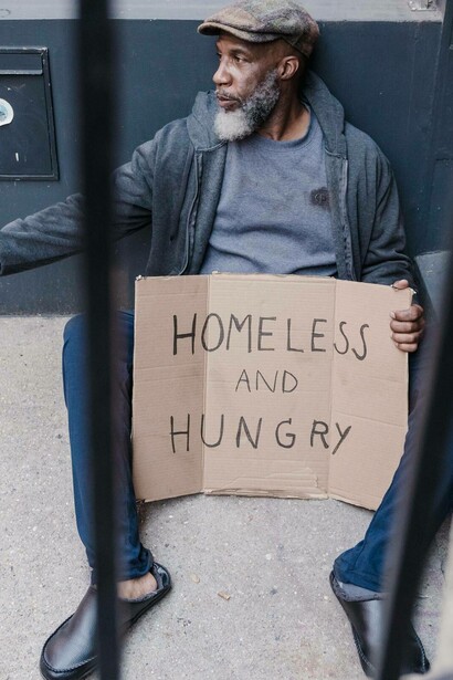 Man with sign homeless and hungry