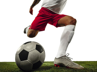 A football player in motion against a white background