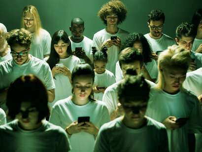 In a sea of faces, our attention is monopolised by the glow of our devices, disconnected yet connected
