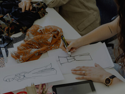 A fashion designer focused on sketching new clothing concepts