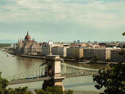 A brown and white historic building overlooking the Danube River in Budapest, where the waterfront reflects the layered history of Buda and Pest, Budapest, Hungary