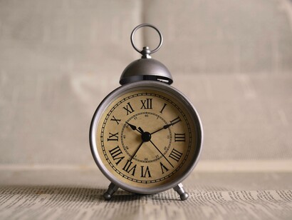 A stylish alarm clock with roman numerals suggesting that time is precious and always ticking away