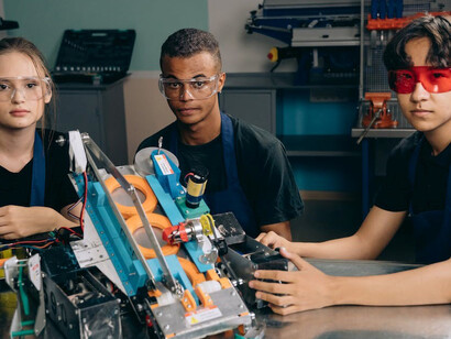 Teenagers harnessing the power of technology and artificial intelligence in an ethical manner, collaboratively crafting something genuinely advantageous