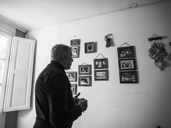 Man reflecting on family memories in a black-and-white photograph