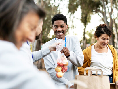 Volunteers collecting food donations, offering helping hands, and fostering human connection through acts of kindness and support