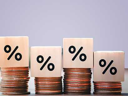 Brand failure depicted: wooden cubes with percentage sign, stack of coin bar chart, and downward trending red graph on white background