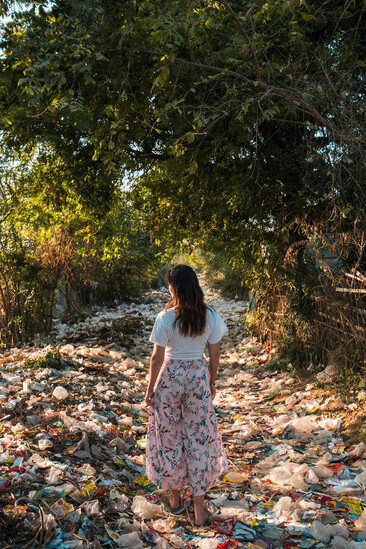 In Myanmar, plastic waste piles up near trees and fills the river