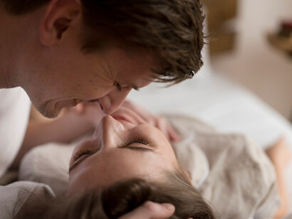 A couple in bed, where emotional and sexual maturity defy simple definitions 