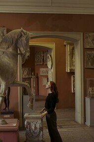 A woman observing artefacts in a museum