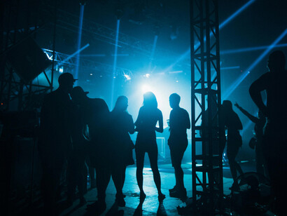 Backstage crew setting up musical instruments for a live performance