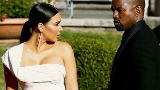 Kim Kardashian and Kanye West in a garden having a minor disagreement