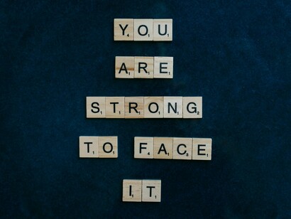 An affirmation displayed against a navy blue backdrop, symbolising the practice of speaking kindly to oneself