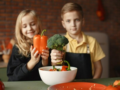 Kids working together in the kitchen, creating a healthy broccoli-based dish, inspired by the goals of the Zero Hunger Initiative