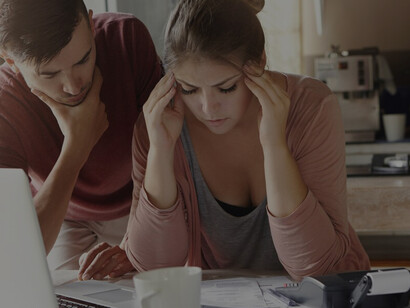 Young family grappling with financial strain and economic worries due to extensive debts