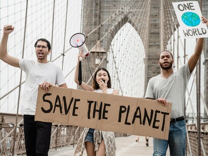 Protesters raising their voices for climate action, symbolizing the movement to hold major polluters responsible for climate damages