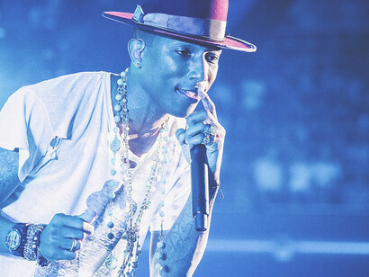 Pharrell Williams on stage in 2014, highlighting his impact on streetwear and fashion trends