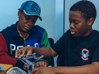 Students working together on a technology project in a tech class in Accra, reflecting how practical learning can turn knowledge into real-world skills