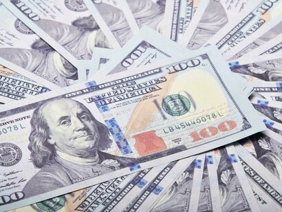 A visible spread of dollar bills, representing the renewed availability of equity financing in 2025