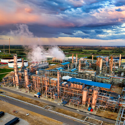 Industrial infrastructure in Rosemount, MN—an oil refinery beneath overcast skies, highlighting fossil fuel dependency