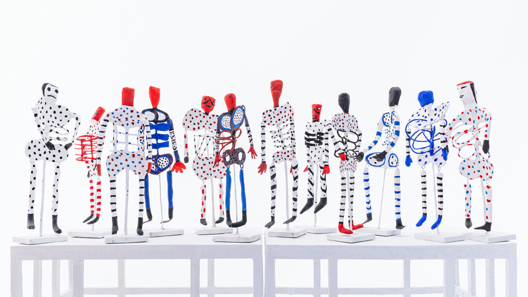 Paper skeleton sculptures on metal stands for the exhibition of Mirades de Murjeres