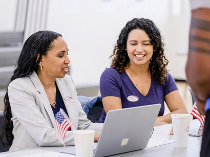 Poll workers use a laptop to assist voters on Election Day in the United States