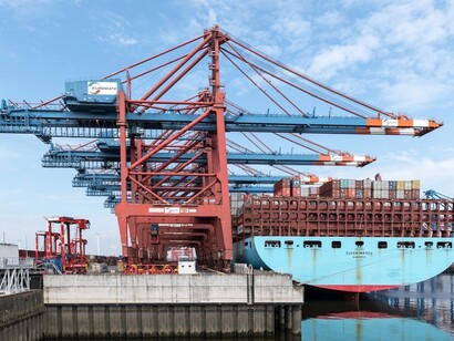 Industrial port cranes loading a container ship at the Port of Hamburg, Germany