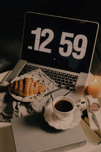 Amidst the cozy embrace of autumn's ambiance, the scene unfolds: life's simple pleasures, watching movies on a computer, and savoring coffee 