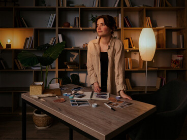 A woman lingering beside her worktable in silence, representing the loneliness hidden within artistic pursuit