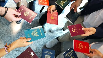 Passports of Wikimania delegates from 11 different countries, reflecting global diversity in mobility and access