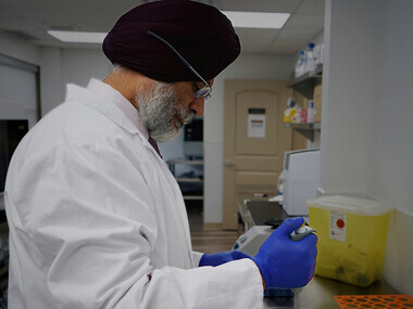 Scientist in a lab analyzing data to evaluate the effectiveness of medical treatments