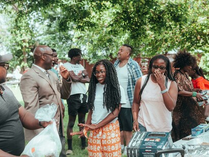People meeting in a park for a social event, symbolizing community life, shared moments, genuine human connection, and a strong sense of unity