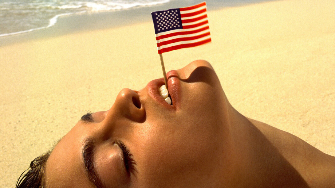 Albert Watson, Cindy Crawford with flag, U.S. Virgin Islands, 1993. Courtesy of Fahey/Klein Gallery