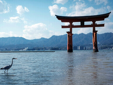 Hiroshima, Japan, featuring the iconic Itsukushima Shrine on Miyajima Island, with a picturesque view of 1-1 Miyajimacho in Hatsukaichi, Japan, showcasing traditional architecture and natural beauty