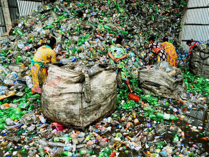 In the shadow of towering landfills, environmental advocates illustrate the human cost of corporate greed and regulatory failures in waste management