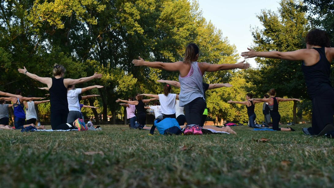 A group of people practicing yoga outdoors