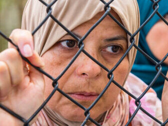 Middle Eastern refugee woman affected by Safe Third Countries policy amid Mediterranean migration crisis