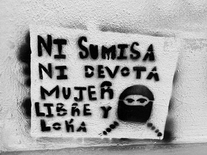 Spanish feminist graffiti reading 'Neither submissive nor devout, a free and crazy woman'