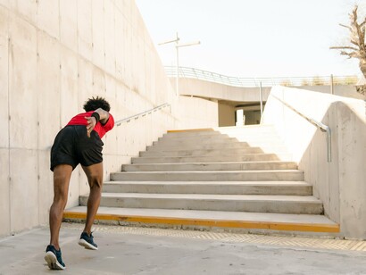 A man making the most of an everyday staircase, representing the benefits of consistent movement over lengthy workouts
