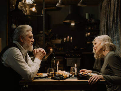 In the glow of candlelight, sharing a beautifully crafted meal offers a moment of serenity and a reminder that even in troubled times, we can find pleasure and connection