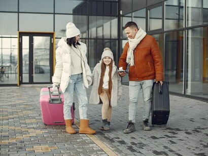 An expat family standing together with luggage and passports, navigating the challenges of starting a new life abroad